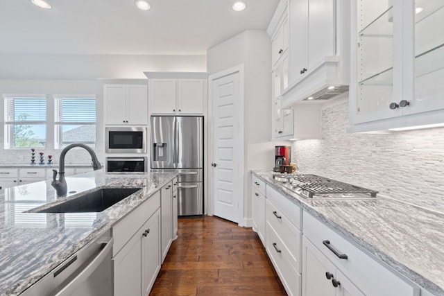 164 Mary Cornelia Cv, Buda, TX 78610 - kitchen featuring stainless steel appliances, white cabinets, recessed lighting, light stone countertops, and tasteful backsplash