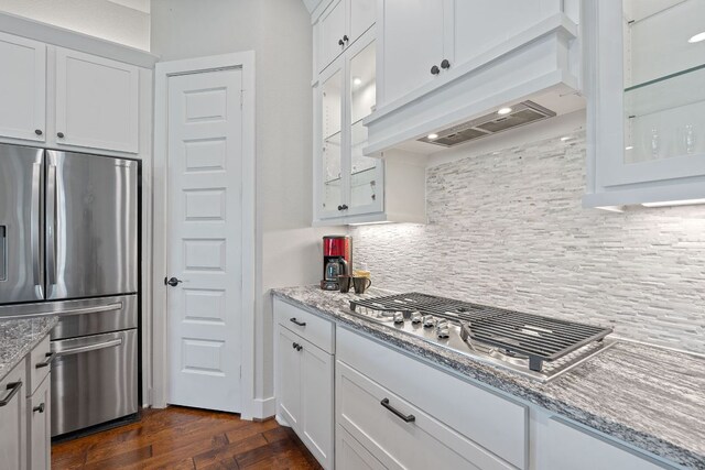 164 Mary Cornelia Cv, Buda, TX 78610 - kitchen with appliances with stainless steel finishes, exhaust hood, and white cabinetry