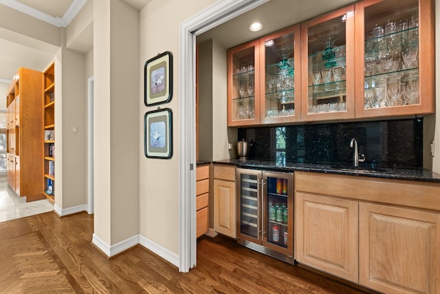 59 Stillmeadow Dr, The Hills, TX 78738 - indoor wet bar with wine cooler, dark wood-style floors, tasteful backsplash, recessed lighting, and crown molding