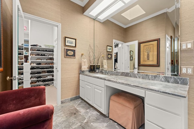 59 Stillmeadow Dr, The Hills, TX 78738 - bathroom featuring crown molding, vanity, marble finish floors, and a walk in closet