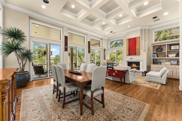 59 Stillmeadow Dr, The Hills, TX 78738 - dining room with a towering ceiling, a warm lit fireplace, crown molding, wood finished floors, and beam ceiling