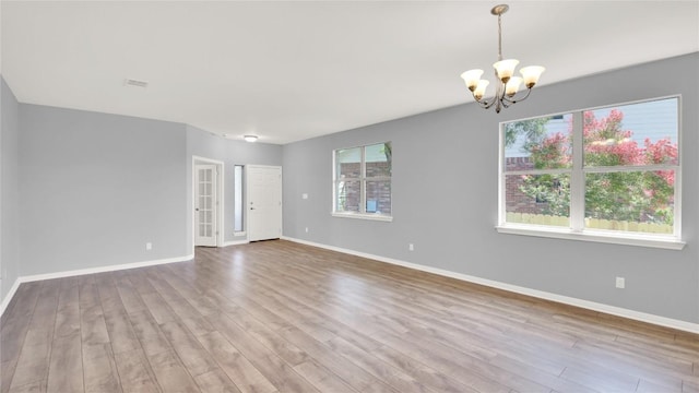 1086 Sussex Way, Round Rock, TX 78665 - spare room with a chandelier and wood finished floors
