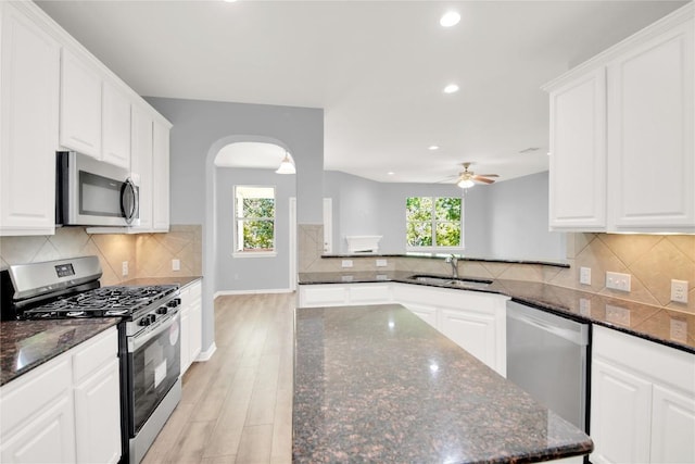 1086 Sussex Way, Round Rock, TX 78665 - kitchen featuring appliances with stainless steel finishes, arched walkways, recessed lighting, ceiling fan, and light wood-type flooring