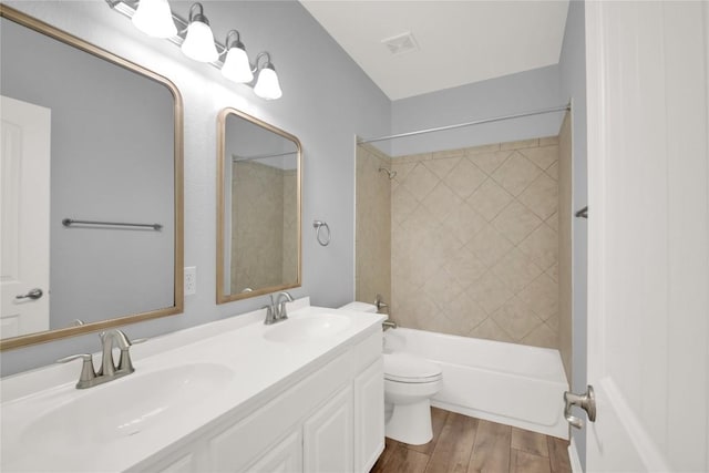 1086 Sussex Way, Round Rock, TX 78665 - bathroom featuring wood finished floors, double vanity, and shower / bathtub combination
