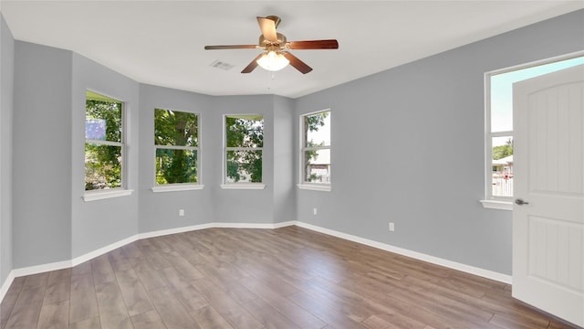 1086 Sussex Way, Round Rock, TX 78665 - unfurnished room featuring healthy amount of natural light, a ceiling fan, and wood finished floors