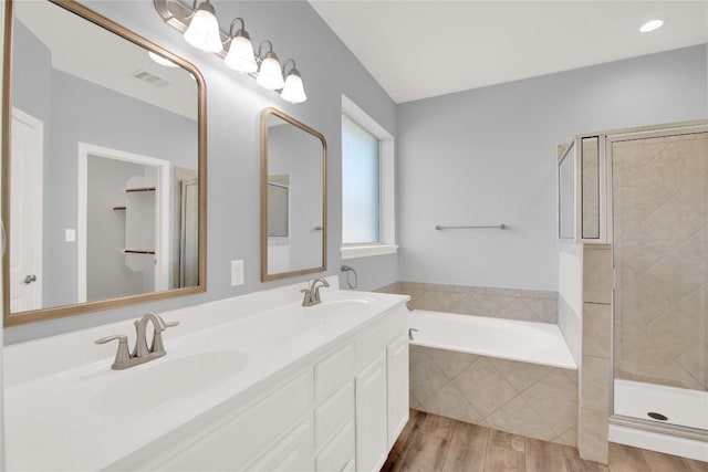 1086 Sussex Way, Round Rock, TX 78665 - full bath featuring a bath, a shower stall, double vanity, and wood finished floors