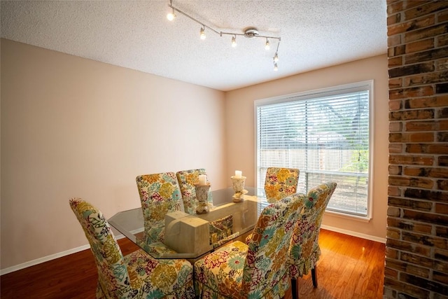 8403 Ardash Ln, Austin, TX 78759 - dining room featuring a textured ceiling and wood finished floors