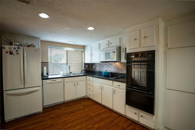8403 Ardash Ln, Austin, TX 78759 - kitchen featuring black appliances, a textured ceiling, dark countertops, backsplash, and dark wood finished floors