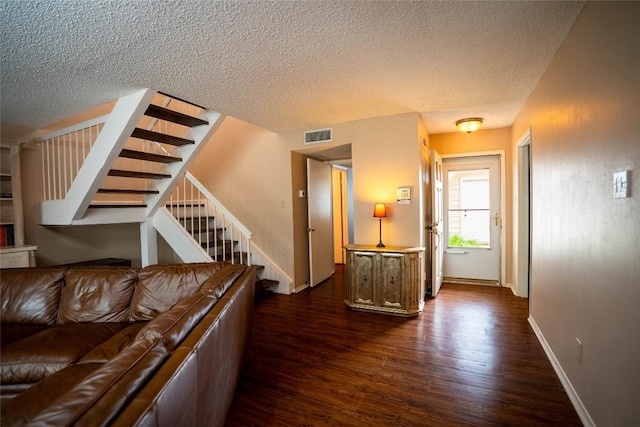 8403 Ardash Ln, Austin, TX 78759 - living room with dark wood-style floors, stairs, and a textured ceiling