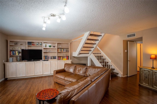 8403 Ardash Ln, Austin, TX 78759 - living room featuring dark wood-style floors, stairs, a textured ceiling, and track lighting