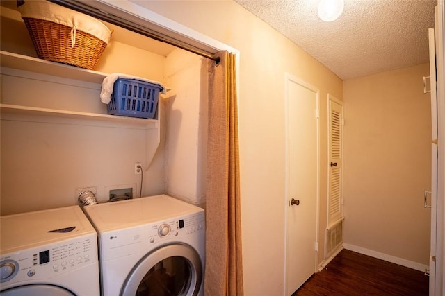 8403 Ardash Ln, Austin, TX 78759 - laundry area with independent washer and dryer, dark wood-style flooring, and a textured ceiling
