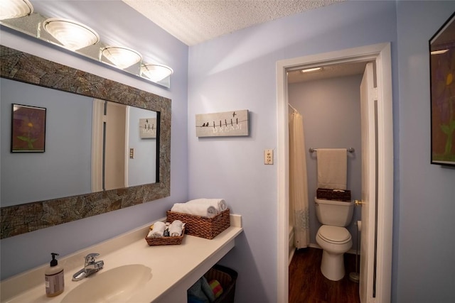 8403 Ardash Ln, Austin, TX 78759 - full bath featuring wood finished floors, a textured ceiling, and vanity