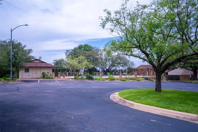8403 Ardash Ln, Austin, TX 78759 - view of asphalt road with street lighting and curbs