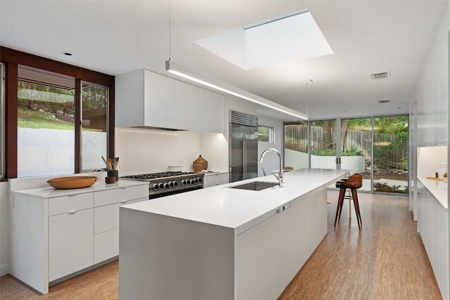 4506 Crestway Dr, Austin, TX 78731 - kitchen featuring stainless steel built in refrigerator, stove, modern cabinets, healthy amount of natural light, and floor to ceiling windows