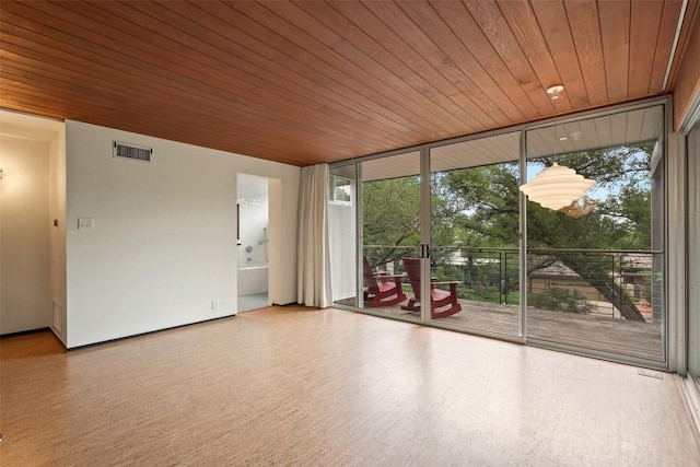 4506 Crestway Dr, Austin, TX 78731 - unfurnished room with a wall of windows and wood finished floors