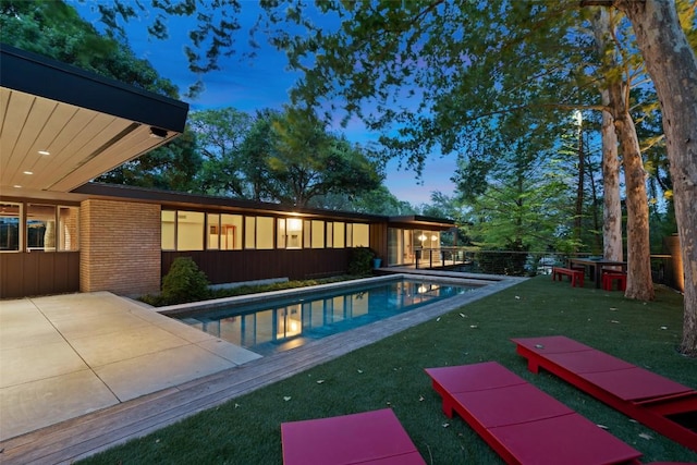 4506 Crestway Dr, Austin, TX 78731 - pool at dusk with a patio and a sunroom