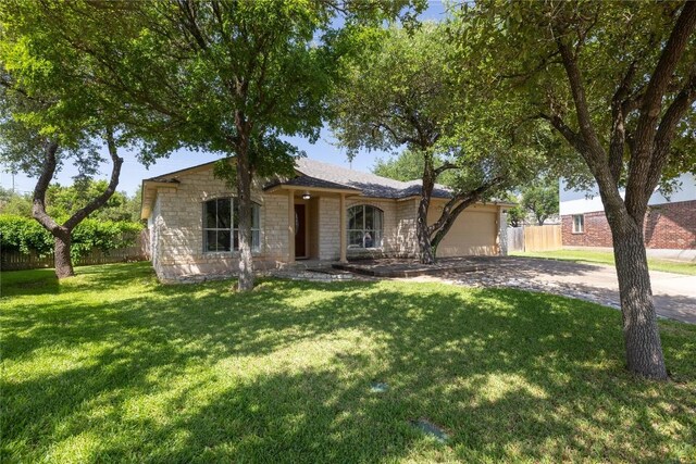 3203 Saint Genevieve Dr, Leander, TX 78641 - ranch-style home with stone siding, driveway, and an attached garage