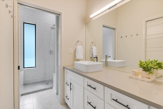 902 W Live Oak St, Austin, TX 78704 - bathroom featuring double vanity, walk in shower, and marble finish flooring