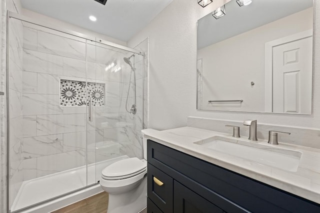 101 Desert Highlands Trl, Round Rock, TX 78665 - bathroom with vanity, a marble finish shower, wood finished floors, and recessed lighting
