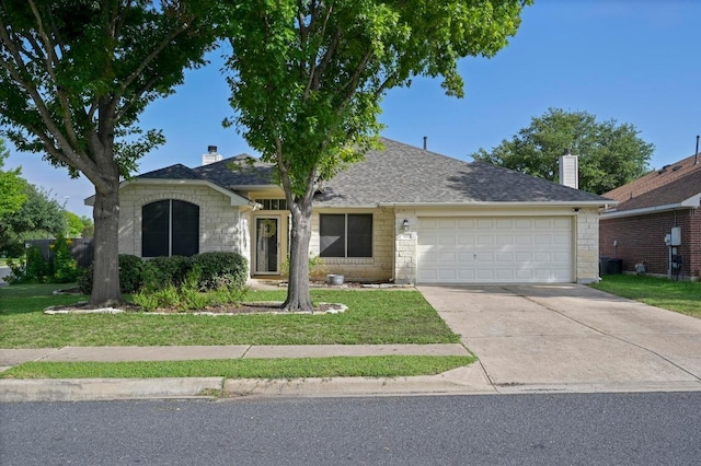 101 Desert Highlands Trl, Round Rock, TX 78665 - view of front of home with concrete driveway, a garage, a front lawn, and stone siding