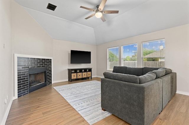 101 Desert Highlands Trl, Round Rock, TX 78665 - living room with a ceiling fan, light wood-style flooring, lofted ceiling, and a tiled fireplace