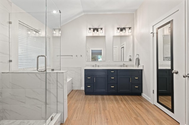 101 Desert Highlands Trl, Round Rock, TX 78665 - bathroom with double vanity, a garden tub, wood finished floors, a stall shower, and lofted ceiling