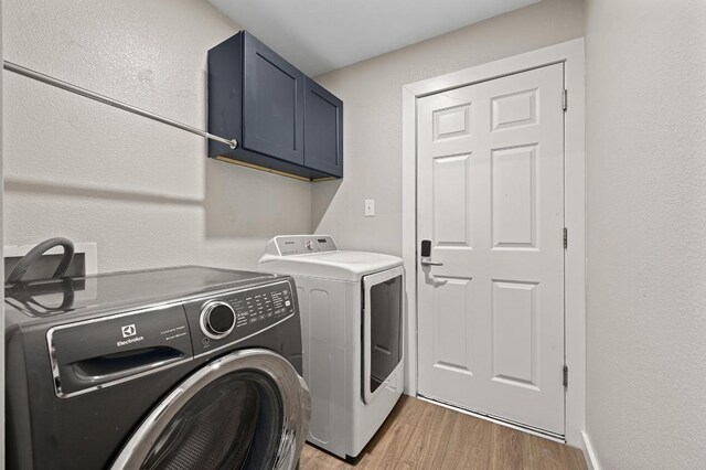 101 Desert Highlands Trl, Round Rock, TX 78665 - washroom featuring cabinet space, washer and clothes dryer, and light wood-type flooring