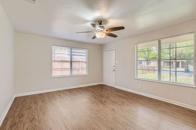 4805 Hilldale Dr, Austin, TX 78723 - spare room with wood finished floors, a ceiling fan, and plenty of natural light