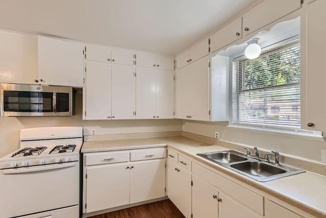 4805 Hilldale Dr, Austin, TX 78723 - kitchen with stainless steel microwave, white range with gas stovetop, white cabinetry, and light countertops