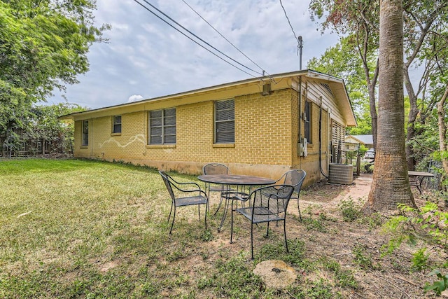 4805 Hilldale Dr, Austin, TX 78723 - rear view of property with brick siding and a yard