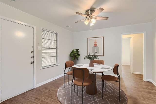 4805 Hilldale Dr, Austin, TX 78723 - dining space featuring wood finished floors, ceiling fan, and crown molding