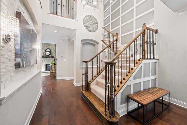 108 Kildrummy Ln, Lakeway, TX 78738 - stairs with hardwood / wood-style floors, a towering ceiling, crown molding, and arched walkways