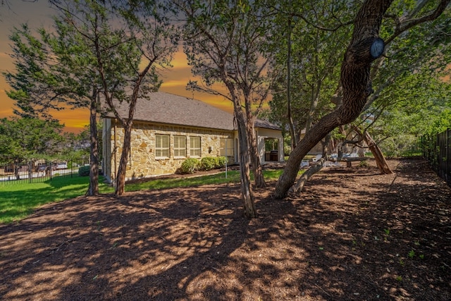108 Kildrummy Ln, Lakeway, TX 78738 - back of property with stone siding and a shingled roof