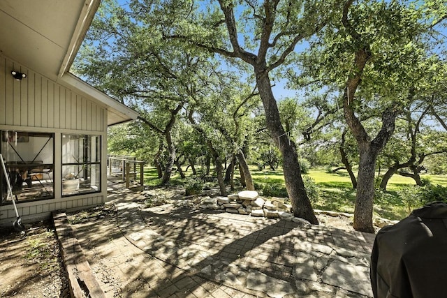 11803 Jess Dr, Austin, TX 78737 - view of patio with a sunroom, a grill, and view of wooded area