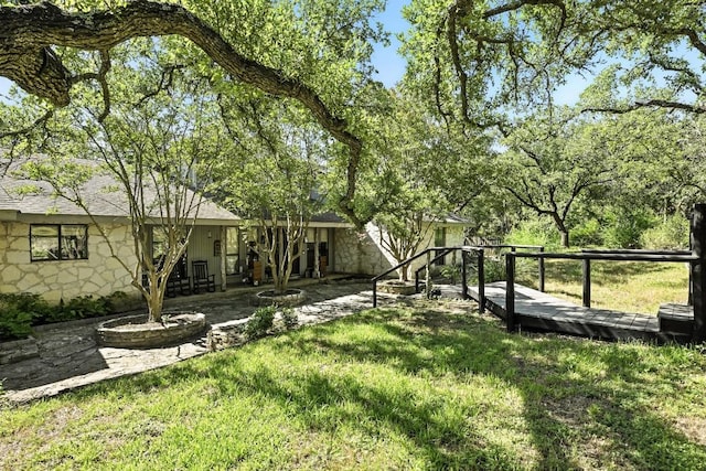 11803 Jess Dr, Austin, TX 78737 - view of grassy yard featuring a deck and a patio area