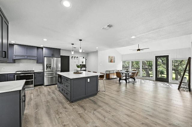 11803 Jess Dr, Austin, TX 78737 - kitchen featuring appliances with stainless steel finishes, recessed lighting, light countertops, light wood-type flooring, and a ceiling fan