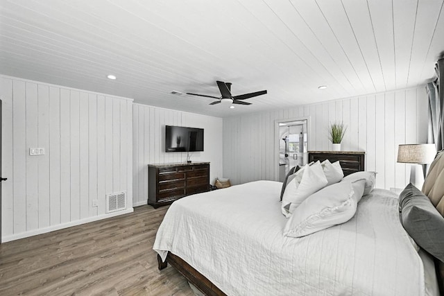 11803 Jess Dr, Austin, TX 78737 - bedroom with wood finished floors, ceiling fan, and wooden walls