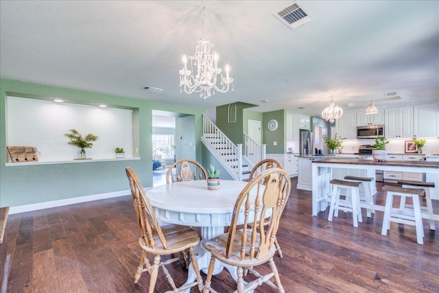 200 S Prairie Ln, Georgetown, TX 78633 - dining room with a chandelier, stairs, and dark wood-style floors