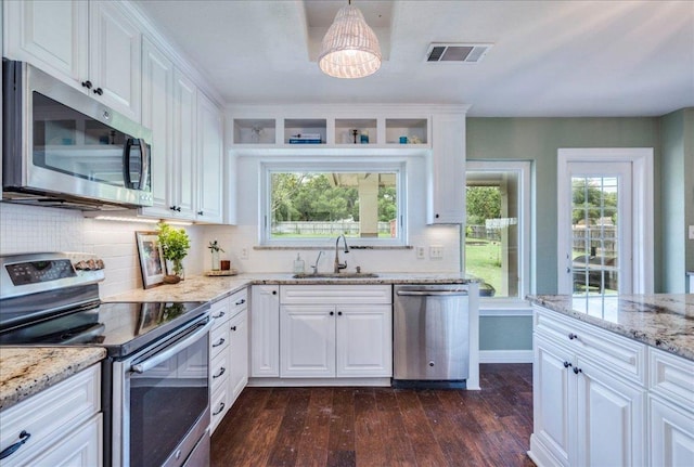200 S Prairie Ln, Georgetown, TX 78633 - kitchen featuring appliances with stainless steel finishes, dark wood finished floors, a chandelier, backsplash, and white cabinets