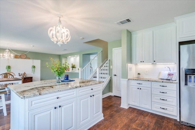 200 S Prairie Ln, Georgetown, TX 78633 - kitchen featuring stainless steel fridge, a chandelier, decorative backsplash, and dark wood finished floors