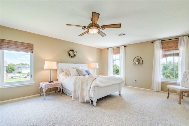 200 S Prairie Ln, Georgetown, TX 78633 - bedroom with multiple windows, carpet floors, and a ceiling fan