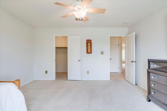 200 S Prairie Ln, Georgetown, TX 78633 - bedroom featuring light colored carpet, a walk in closet, and ceiling fan