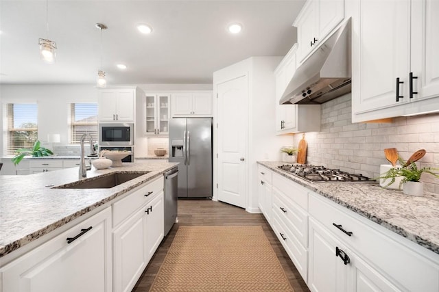 2541 Reunion Blvd, Austin, TX 78737 - kitchen featuring stainless steel appliances, under cabinet range hood, white cabinetry, tasteful backsplash, and recessed lighting