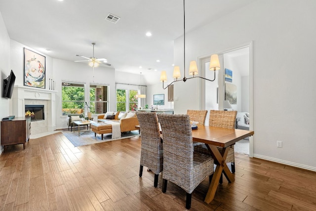 2977 Diego Dr, Round Rock, TX 78665 - dining space with hardwood / wood-style floors, a ceiling fan, a fireplace, and recessed lighting