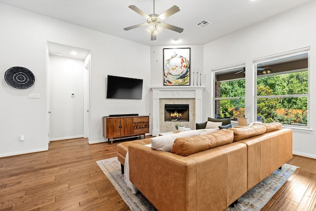 2977 Diego Dr, Round Rock, TX 78665 - living room with a ceiling fan, light wood-style flooring, a high end fireplace, and recessed lighting