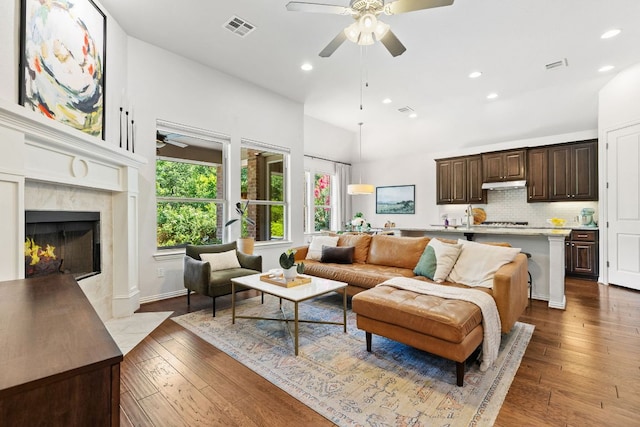 2977 Diego Dr, Round Rock, TX 78665 - living area featuring a ceiling fan, dark wood-style floors, recessed lighting, and a premium fireplace