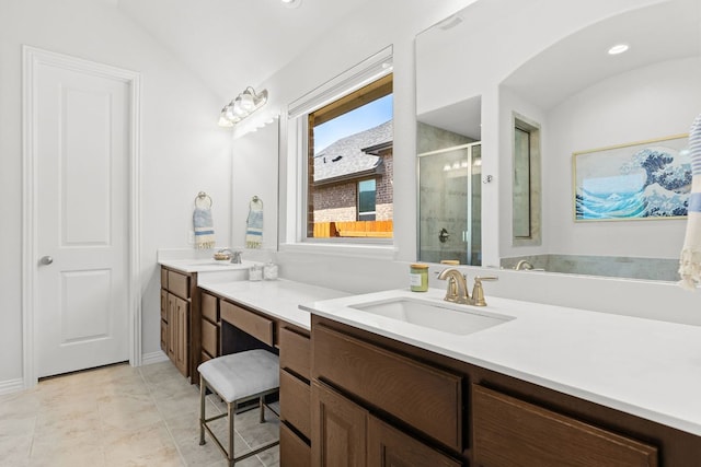 2977 Diego Dr, Round Rock, TX 78665 - bathroom featuring lofted ceiling, a shower stall, and double vanity