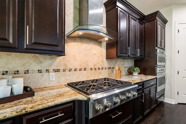 201 Montalcino Blvd, Austin, TX 78734 - kitchen featuring wall chimney exhaust hood, stainless steel gas cooktop, dark wood finished floors, and light stone counters