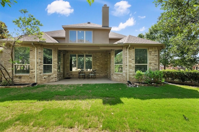 201 Montalcino Blvd, Austin, TX 78734 - rear view of house featuring brick siding, a patio area, and a yard