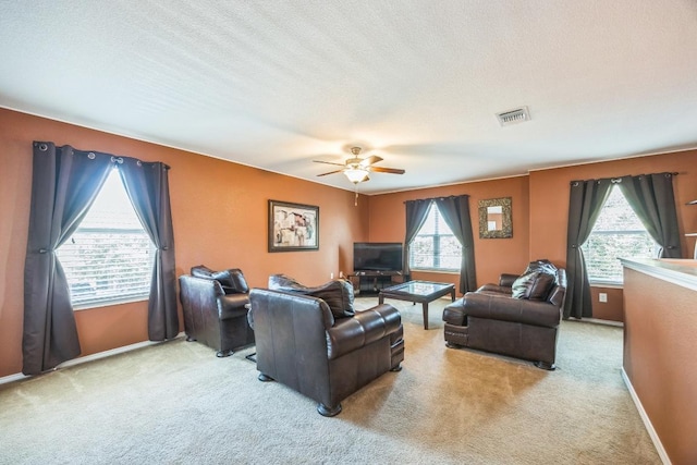 6401 Quinton Dr, Austin, TX 78747 - carpeted living room with ceiling fan and a textured ceiling